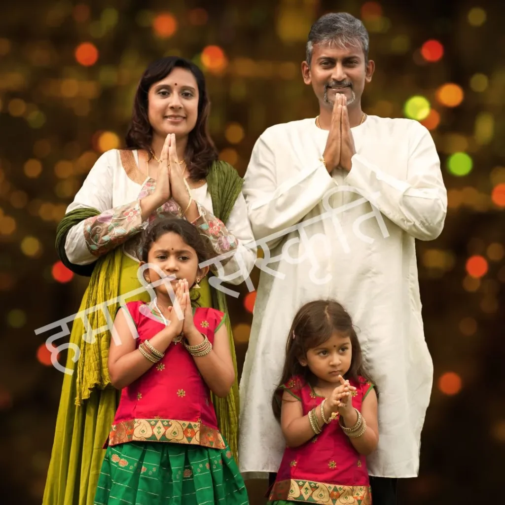 Family in Indian traditional attire in Namaste pose, symbol of culture and family values.